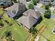 Drone shot of the roof and back of the home. The backyard has green grass and a seating area at 4440 Atwood Dr, Cumming, GA 30040