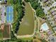 Aerial view of the community, featuring a pool, a pond, tennis courts, clubhouse, and a playground among lush landscaping at 4440 Atwood Dr, Cumming, GA 30040