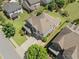 An aerial view of a gray home featuring a manicured lawn, mature trees, and a spacious driveway in a residential neighborhood at 4440 Atwood Dr, Cumming, GA 30040