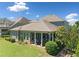 Stunning exterior shot of the home showcasing the covered patio, lush green lawn, and beautiful landscaping at 4440 Atwood Dr, Cumming, GA 30040