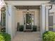 Welcoming front porch with brick pillars, overhead light, seasonal wreath, and greenery at 4440 Atwood Dr, Cumming, GA 30040