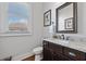 Stylish half bathroom featuring granite countertop, dark wood cabinet, modern fixtures, and natural light at 4440 Atwood Dr, Cumming, GA 30040