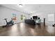 Spacious living room featuring hardwood floors, a comfortable seating area, and plenty of natural light at 4440 Atwood Dr, Cumming, GA 30040