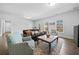 Cozy living room with ample natural light, comfortable seating, and hardwood floors at 4440 Atwood Dr, Cumming, GA 30040