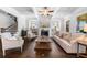 Bright living room boasts hardwood floors, coffered ceilings, fireplace, and lots of natural light at 4440 Atwood Dr, Cumming, GA 30040