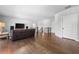Open living space with hardwood flooring, a comfortable sofa, and a large flat-screen TV at 4440 Atwood Dr, Cumming, GA 30040