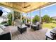 Covered outdoor patio with a ceiling fan, grill, and comfortable seating at 4440 Atwood Dr, Cumming, GA 30040