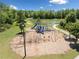 A community playground featuring a variety of play structures, swings, slides and natural surroundings with seating and pathways at 4440 Atwood Dr, Cumming, GA 30040