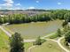Community pond surrounded by walking paths, mature trees, and lush landscaping, providing a serene and natural setting at 4440 Atwood Dr, Cumming, GA 30040