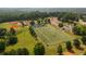 Aerial view of a neighborhood park featuring a baseball field, football field and inflatables for Gathering-friendly recreation at 506 Healy Dr # 74, Cumming, GA 30040