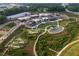 Aerial view of the community with green spaces, walking paths, mini golf and retail buildings at 506 Healy Dr # 74, Cumming, GA 30040