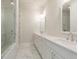 Elegant bathroom featuring a double vanity, marble floors and walls, and glass shower at 506 Healy Dr # 74, Cumming, GA 30040