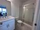 Modern bathroom with a sleek glass-enclosed shower, contemporary fixtures, and stylish tile flooring at 506 Healy Dr # 74, Cumming, GA 30040