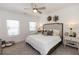 Cozy bedroom features a comfortable bed, soft carpet, and a ceiling fan for added comfort at 506 Healy Dr # 74, Cumming, GA 30040