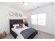 Comfortable bedroom with a dark-wood bed, large window, and contemporary decorative touches at 506 Healy Dr # 74, Cumming, GA 30040