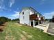Charming new home with white siding, black trim, and a well-manicured lawn, inviting you to settle in at 506 Healy Dr # 74, Cumming, GA 30040