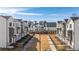 New construction townhomes feature modern architecture with white exteriors, dark accents, and landscaped common areas at 506 Healy Dr # 74, Cumming, GA 30040