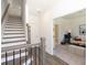 Welcoming foyer with staircase, wood floors, and an open view into a cozy living area with modern decor at 506 Healy Dr # 74, Cumming, GA 30040