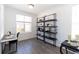 Bright home office features a window, stylish desk, and decorative shelving with tasteful decor at 506 Healy Dr # 74, Cumming, GA 30040