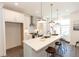 Bright kitchen featuring white cabinets, an island with bar seating, and stainless steel appliances at 506 Healy Dr # 74, Cumming, GA 30040