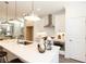 Contemporary kitchen showcasing white cabinets, stainless steel appliances, and a central island with bar seating at 506 Healy Dr # 74, Cumming, GA 30040
