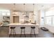 Modern kitchen with white cabinets, stainless steel appliances, a central island, and pendant lighting at 506 Healy Dr # 74, Cumming, GA 30040
