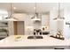 Bright kitchen featuring white cabinets, stainless steel appliances, a quartz countertop island with a sink at 506 Healy Dr # 74, Cumming, GA 30040