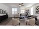 Bright living room features neutral furniture, an area rug, and a ceiling fan at 506 Healy Dr # 74, Cumming, GA 30040