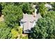 Aerial shot showcases the unique architecture and private, wooded setting of this home at 55 Bransford Rd, Sandy Springs, GA 30324