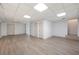 Spacious basement with light, wood-look flooring, white walls, and multiple closets at 55 Bransford Rd, Sandy Springs, GA 30324