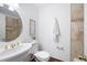 Bathroom featuring a pedestal sink, updated fixtures, a large mirror, and tiled shower at 55 Bransford Rd, Sandy Springs, GA 30324