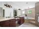 Luxurious bathroom with double vanity, soaking tub, and tiled walls at 55 Bransford Rd, Sandy Springs, GA 30324