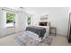 Bright bedroom with neutral tones, decorative rug, and sheer window coverings at 55 Bransford Rd, Sandy Springs, GA 30324