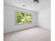 Bright bedroom featuring neutral carpet, light walls, and a large window offering backyard views at 55 Bransford Rd, Sandy Springs, GA 30324