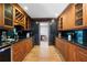 Butler pantry features black granite countertops, wood cabinetry, tile backsplash, and wine rack at 55 Bransford Rd, Sandy Springs, GA 30324
