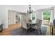 Bright dining room features hardwood floors, a modern chandelier, and a round dining table with seating for four at 55 Bransford Rd, Sandy Springs, GA 30324