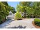 Charming exterior with a lush front yard, mature trees, and a long driveway at 55 Bransford Rd, Sandy Springs, GA 30324