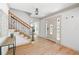 Bright foyer with hardwood floors, staircase with iron railing and decorative glass front door at 55 Bransford Rd, Sandy Springs, GA 30324