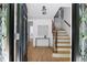 Bright foyer with hardwood floors, staircase with iron railing, and decorative glass in the front door at 55 Bransford Rd, Sandy Springs, GA 30324