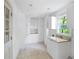 Well-lit laundry room with granite countertops, abundant cabinetry and tiled floor at 55 Bransford Rd, Sandy Springs, GA 30324