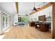 Open-concept living area with high ceilings and abundant natural light leading to kitchen and outdoor patio at 55 Bransford Rd, Sandy Springs, GA 30324