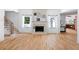 Open living room features hardwood floors, a fireplace, neutral decor, and abundant natural light from sun-filled windows at 55 Bransford Rd, Sandy Springs, GA 30324
