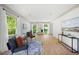 Bright sitting room features hardwood floors, neutral decor, and abundant natural light from the multiple windows at 55 Bransford Rd, Sandy Springs, GA 30324