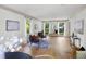 Bright sitting room features hardwood floors, neutral decor, and abundant natural light from the multiple windows at 55 Bransford Rd, Sandy Springs, GA 30324