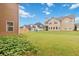 Expansive backyard features lush green grass and views of neighboring houses at 651 Deer Springs Way, Loganville, GA 30052