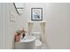 Compact powder room featuring a modern sink, round mirror, and neutral walls at 651 Deer Springs Way, Loganville, GA 30052