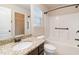Bathroom with granite counter, dark wood cabinets, a mirror, and a shower-tub combo at 651 Deer Springs Way, Loganville, GA 30052