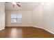 Bright and airy bedroom featuring hardwood floors and natural light from a window at 651 Deer Springs Way, Loganville, GA 30052