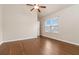 Bright bedroom featuring hardwood floors, a ceiling fan, and a window that provides natural light at 651 Deer Springs Way, Loganville, GA 30052