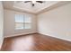 Spacious bedroom with a tray ceiling, window, and hardwood floors at 651 Deer Springs Way, Loganville, GA 30052